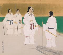 Priests in white robes lined up along the beach