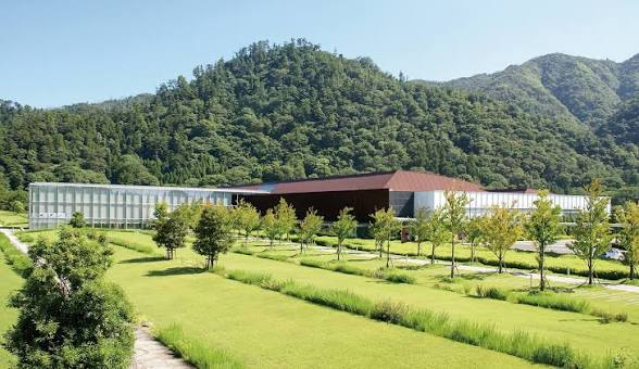 The Shimane Museum of Ancient Izumo, set against a backdrop of lawn and green hills