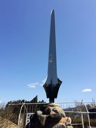 A sword-shaped monument standing at the traditional site of the serpent slaying