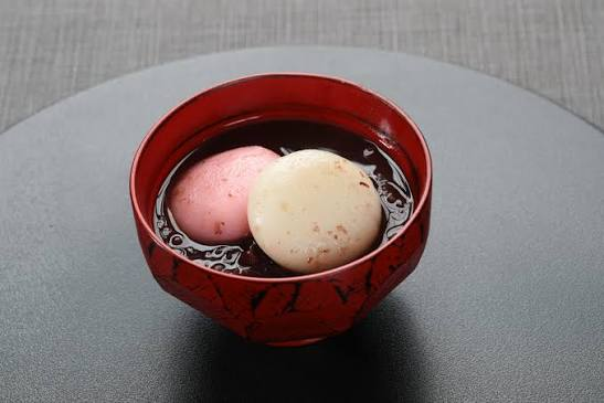 Zenzai served in a lacquerware bowl, with red-and-white mochi dumplings